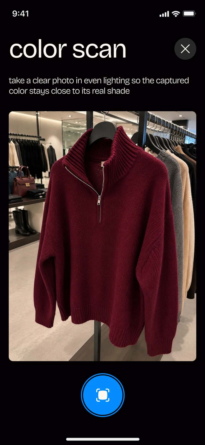 PaletteMe color scan in progress — the camera framing a burgundy knit on a store rack